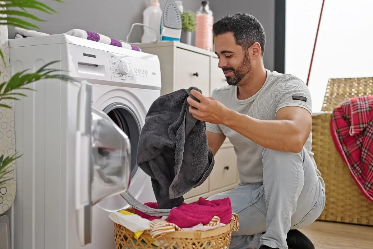 man takes out laundry